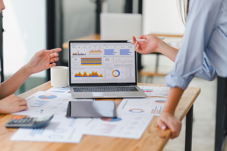 Two members of an inbound strategy team working on data analysis dashboard for business strategy.